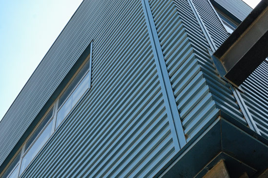 Blue metal exterior siding of a building.